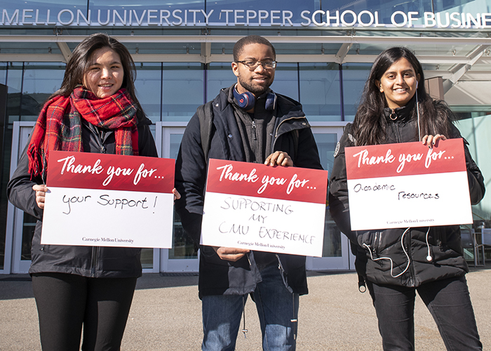 CMU Students Hold Sign Thanking Donors