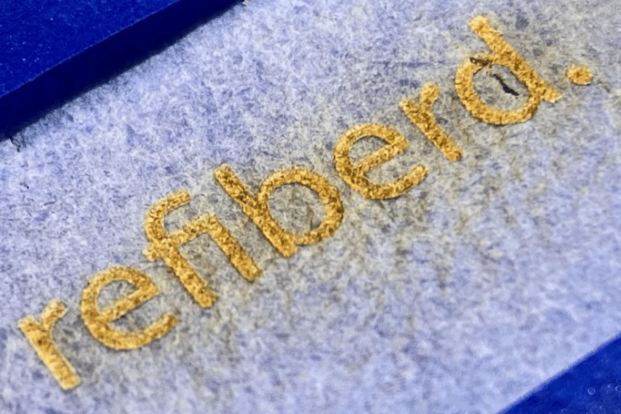 Refiberd's logo on paper made from 100% recycled textiles