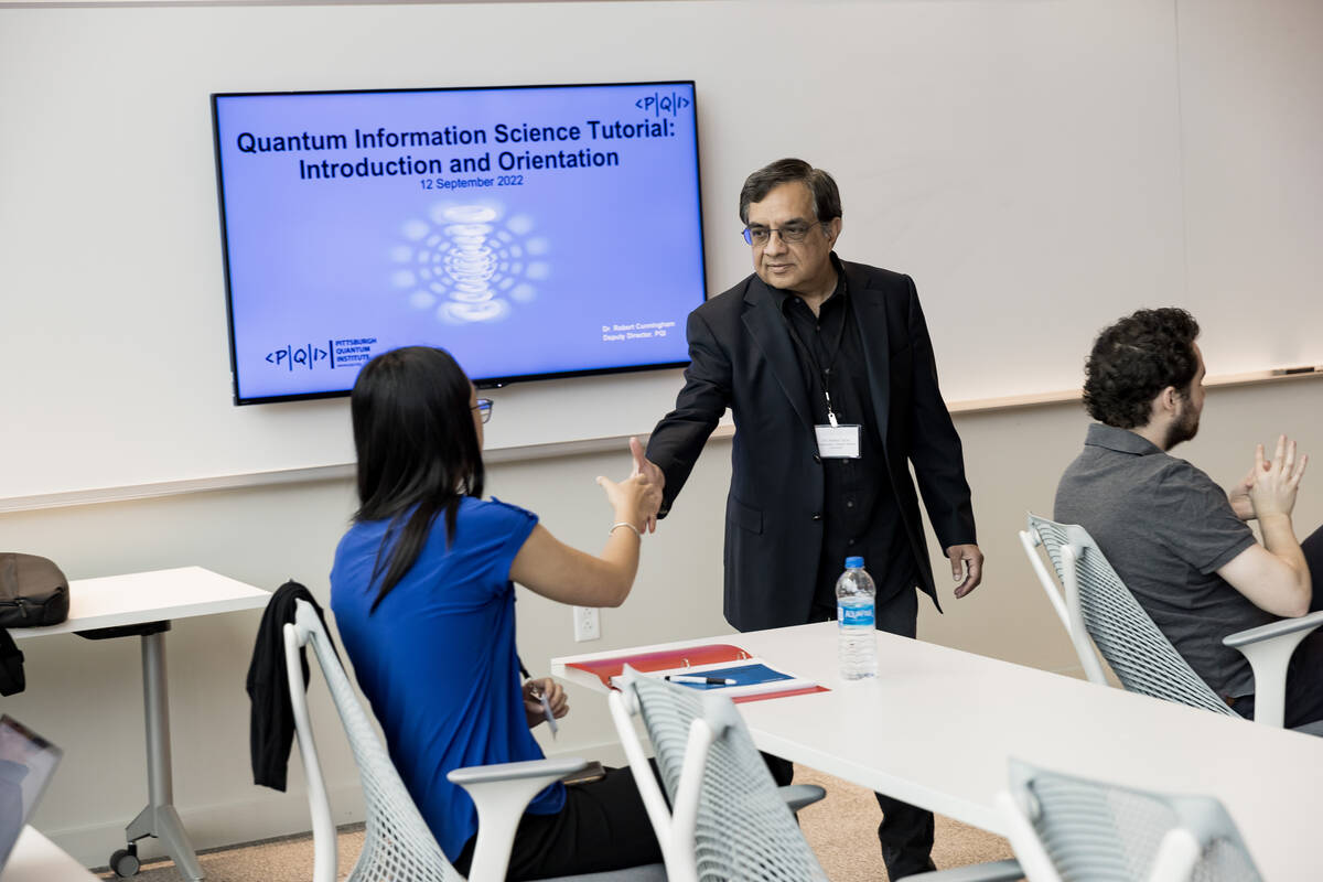 Sridhar Tayur shakes hands with a student.