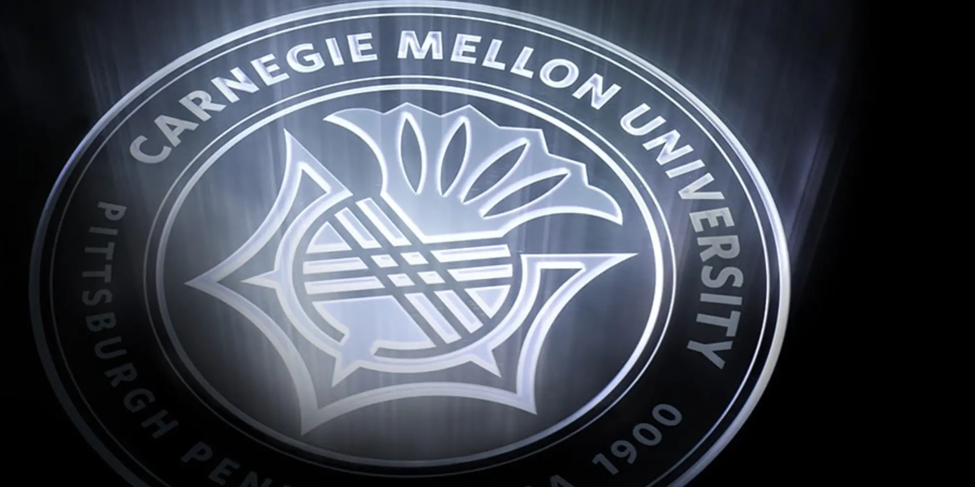 Carnegie Mellon seal lighted on dark background