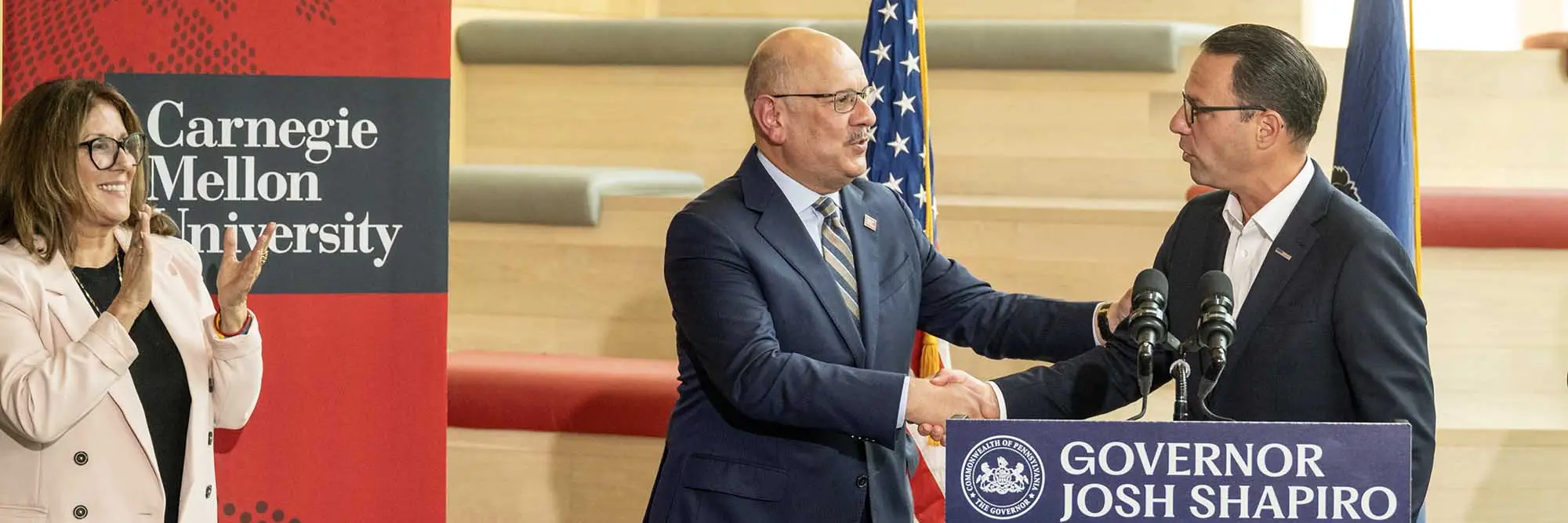 Farnam Jahanian shakes hands with Gov. Josh Shapiro