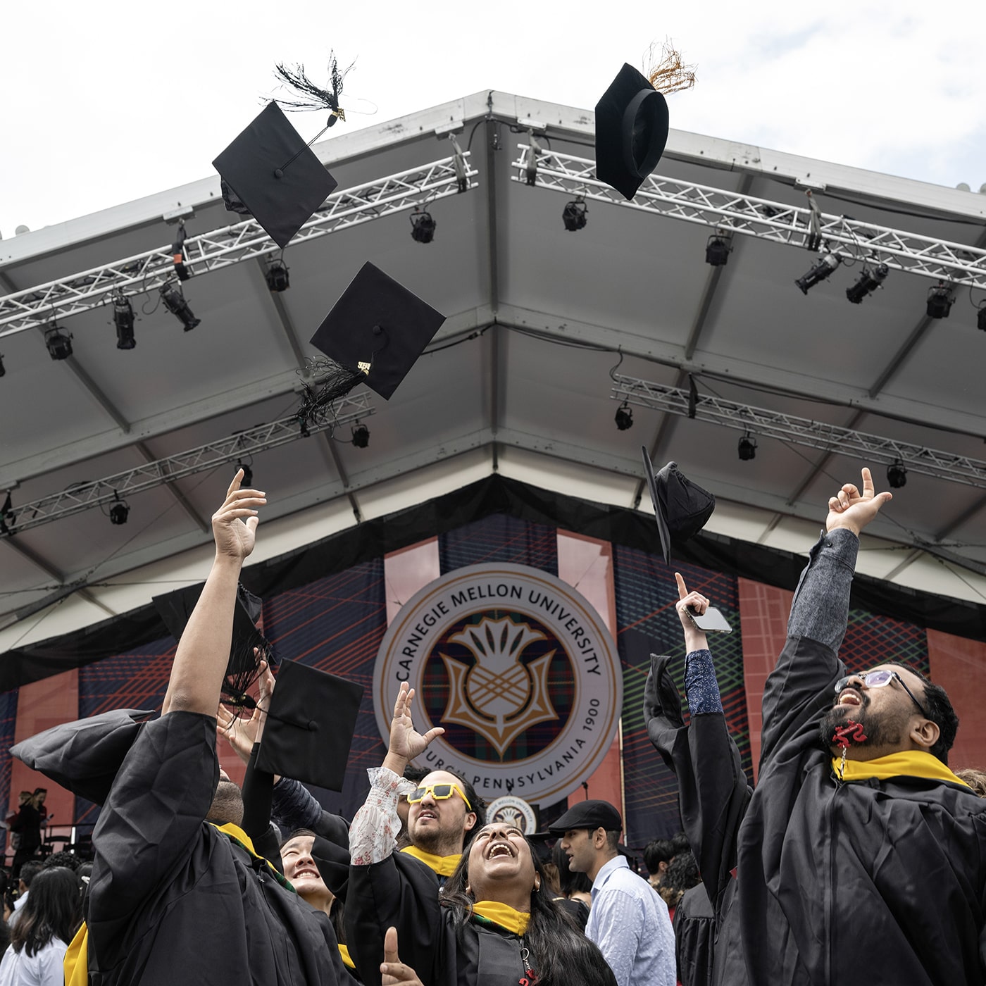 Graduates throw their caps at Commencement.