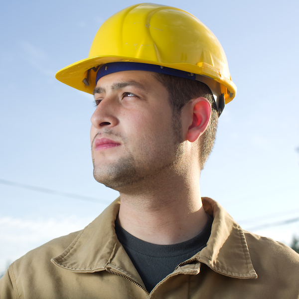 Construction worker looks into distance