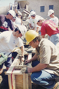 Larry Cartwright during a concrete pour with students