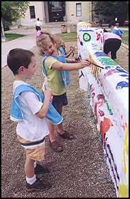 Kids painting The Fence