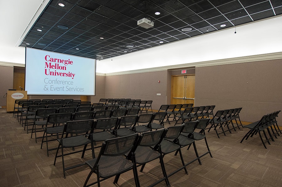 Photo of the Connan Room with of a view of the projector from the audience seating area