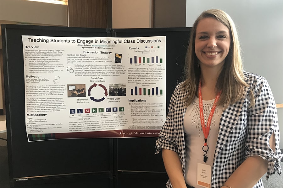 Lexi Adams smiling in front of a research poster