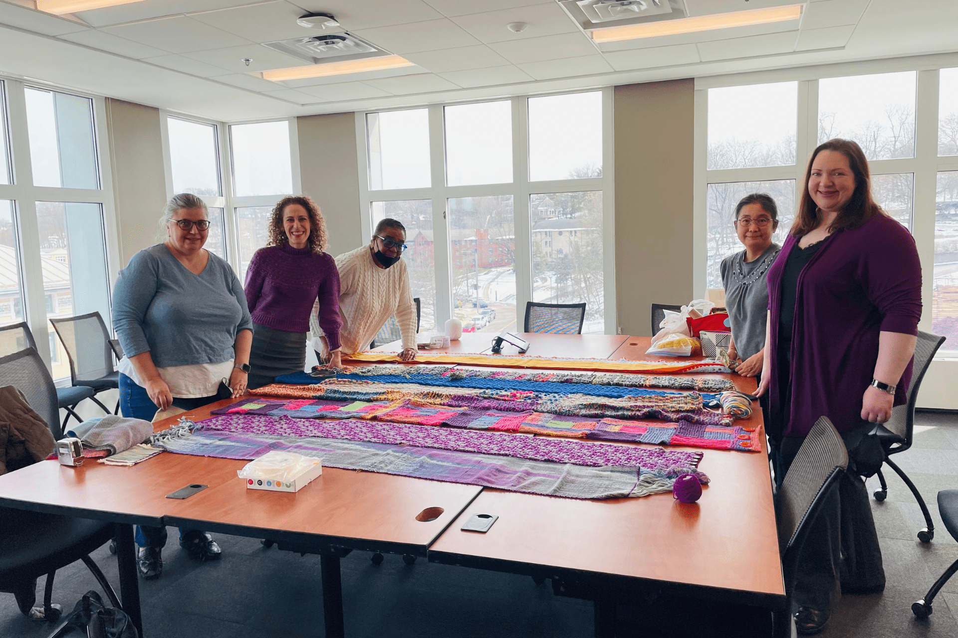 CMU Women's Association Knit & Crochet Club work on sewing together the yarn bomb segments.