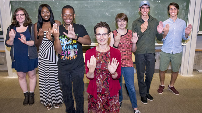 Professor Mandy Simons and students from her Nature of Language course demonstrate a sign from an invented language.