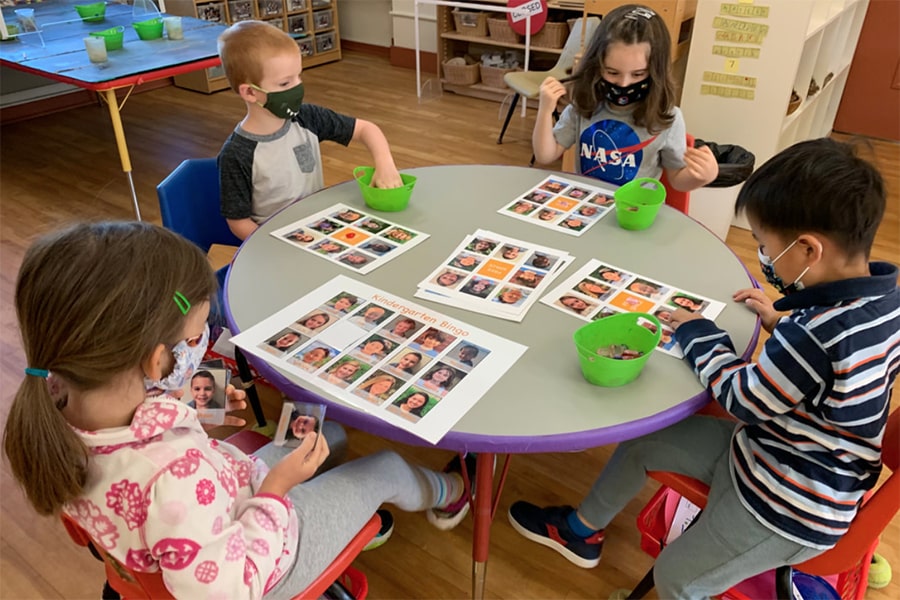 Children wearing masks, playing bingo