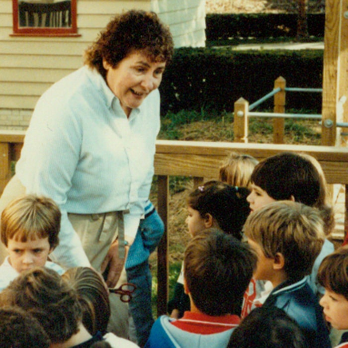 Ann Baldwin Taylor conversing with children on the playground in 1984.