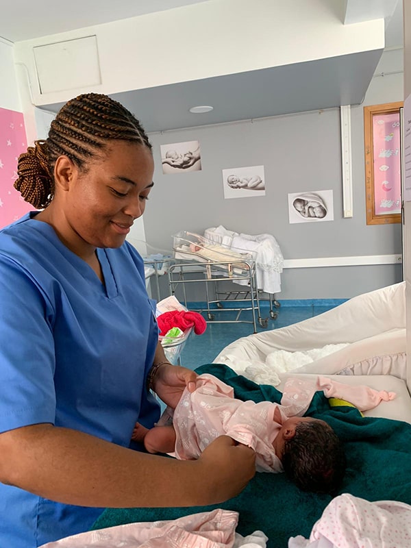 Veronique Wright dressing a baby