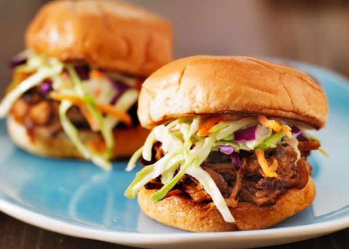 Pulled pork sliders with red cabbage slaw on a brioche bun