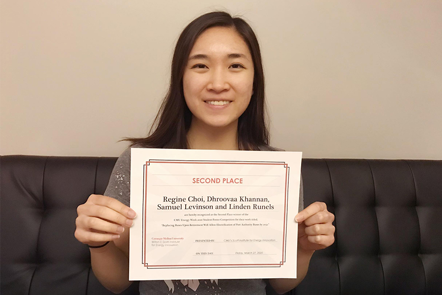 CMU student Regine Choi displays her award certificate for the CMU Energy Week Student Research Poster Competition.