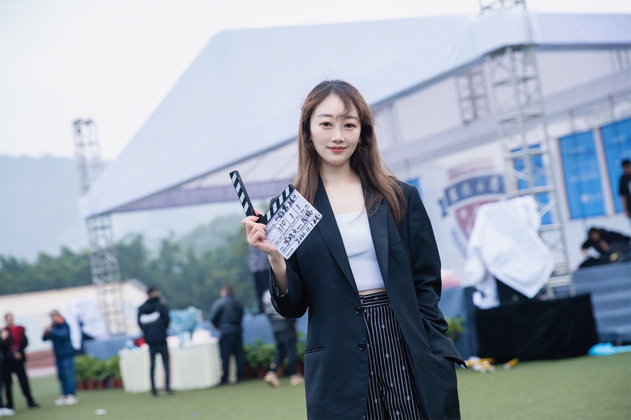 Rachel Song with a clapperboard.