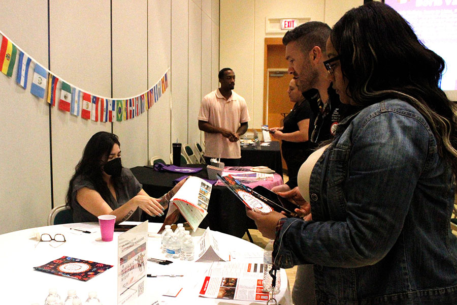 Attendees perusing Latine Faculty and Staff Alliance promotional materials