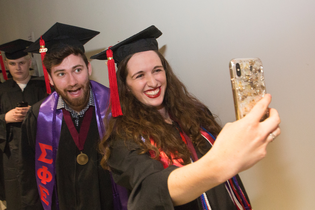 2019 graduates taking selfies.