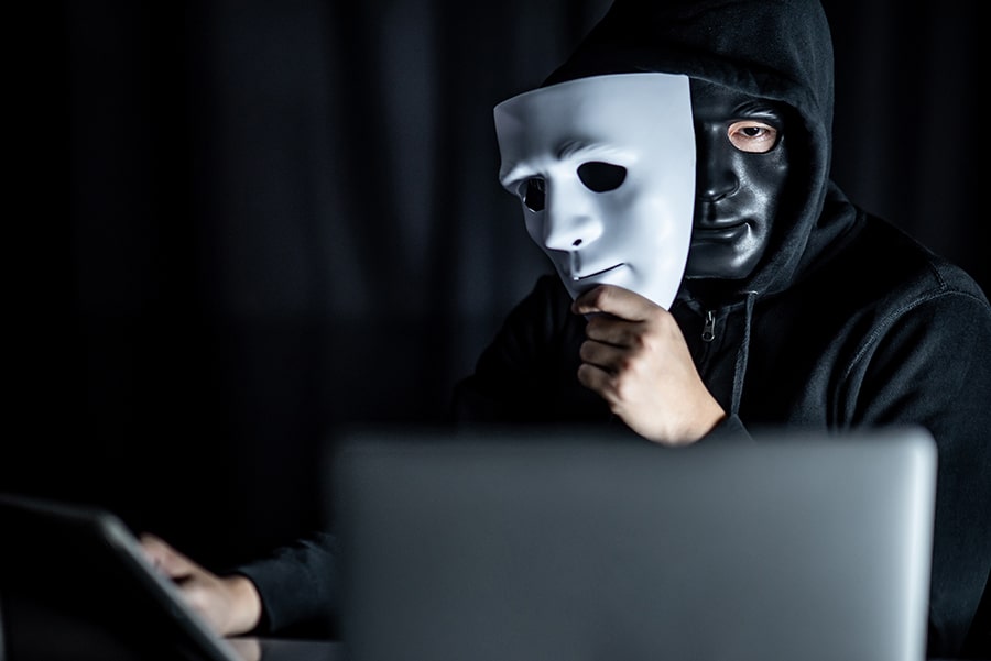 Man with mask on computer