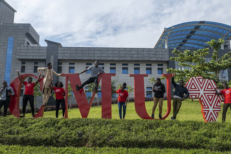 Students at CMU-Africa campus by large CMU letters
