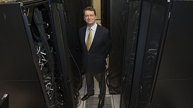 Tuomas Sandholm, one of the brains behind CMU's poker AI agent Libratus, poses with the Pittsburgh Supercomputing Center's Bridges computer.