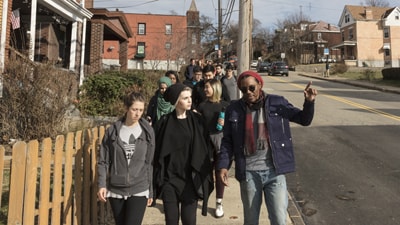 Image of students and Rev. Tim Smith walk through Hazelwood