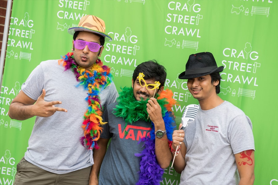Image of three male students with props taking a photo