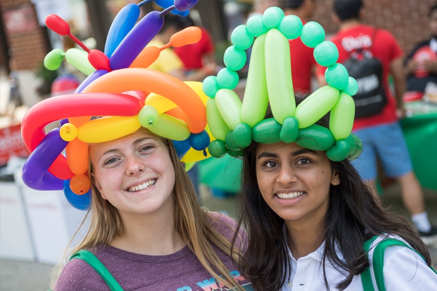 Image of two female students wearing balloon hats