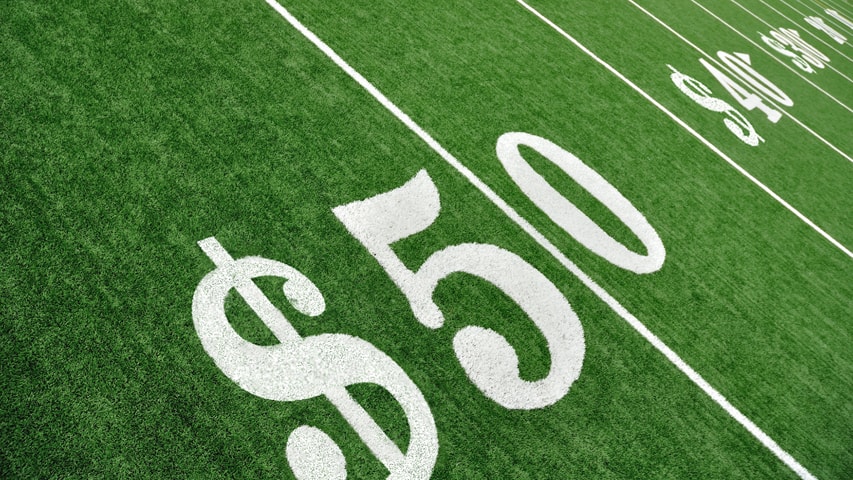 Football field with dollar signs
