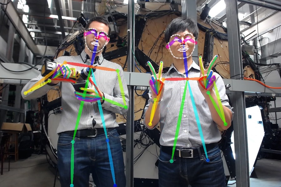 Image of two robotics institute researchers showing how gestures are detected