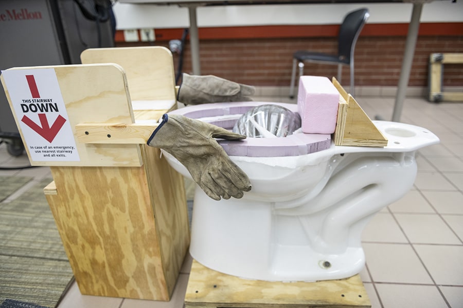 A photo of a bowling ball in a toilet