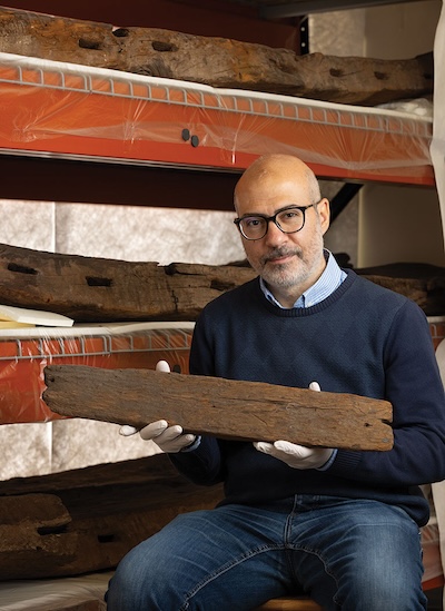 Image of Mostafa Sherif holding a peice of wood