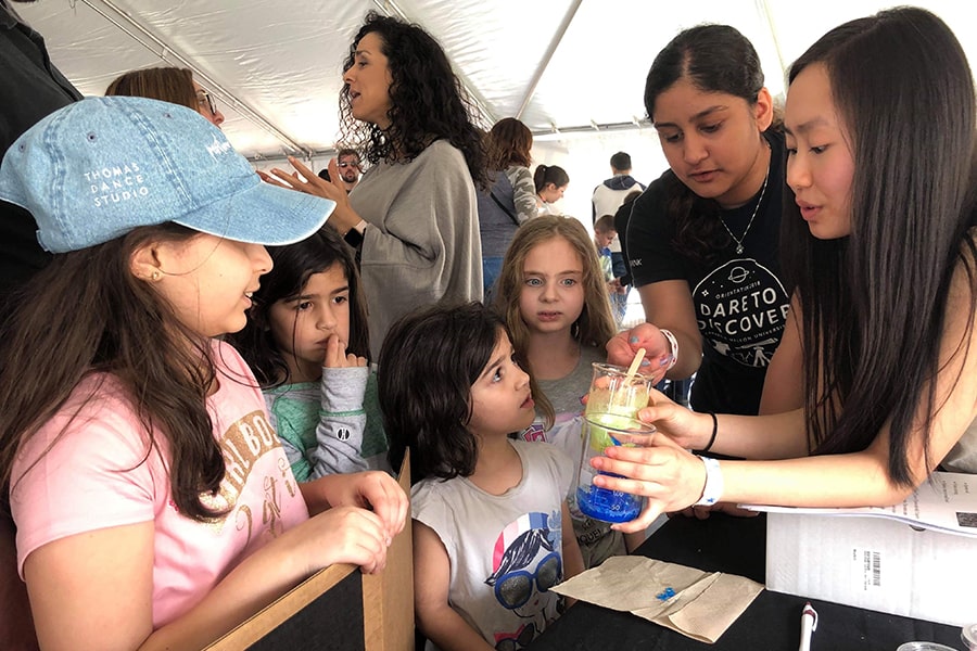 The Women in Science club demonstrates crystal growth to children at Carnival 2019.