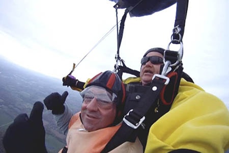 Image of John Marano in the sky during a tandem skydive