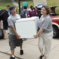 photo of student and parent moving large item
