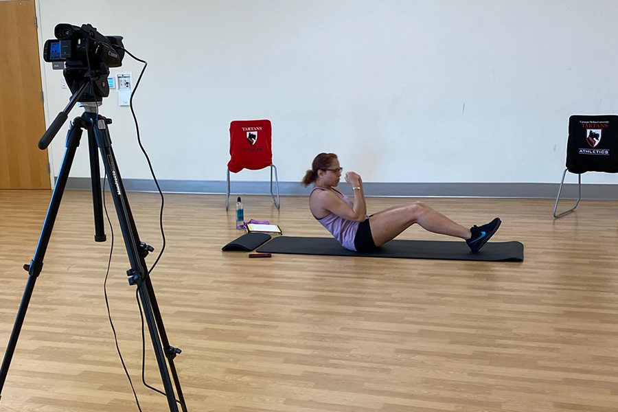 image of fitness trainer being recorded while teaching an exercise class