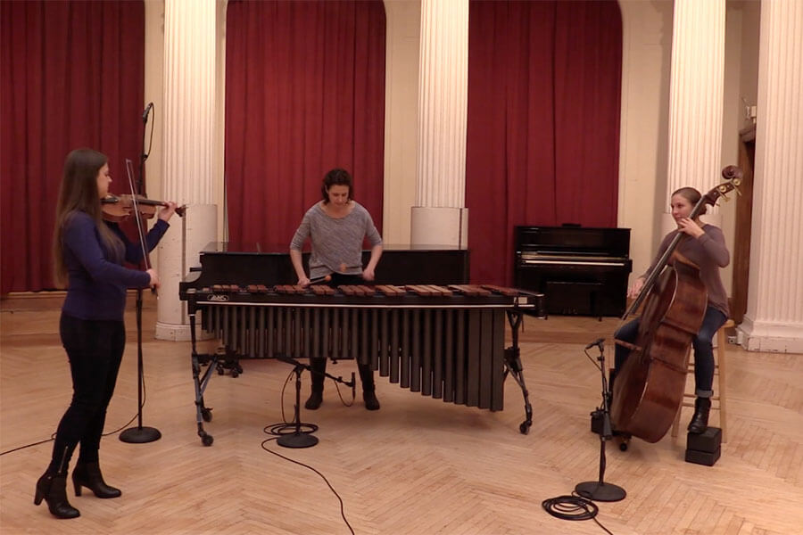 Image of musician trio on inside CMU's College of Fine Arts