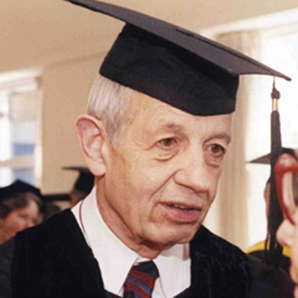 John Nash on campus wearing regalia