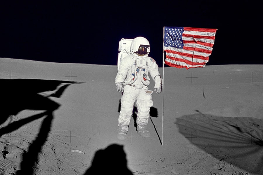 Edgar Mitchell on the Moon with an American flag
