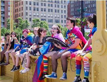 Students sit on a bridge during Pride Month 2019