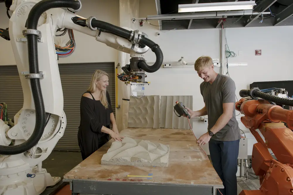 Sculpting concrete panels with robots in an architecture lab.
