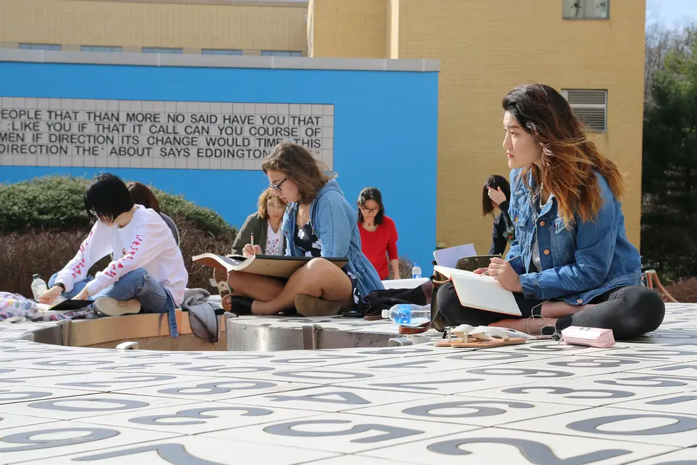 CMU students drawing art outside on CMU's The Kraus Campo