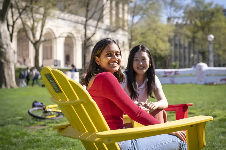 Students relax on campus between classes on a sunny day