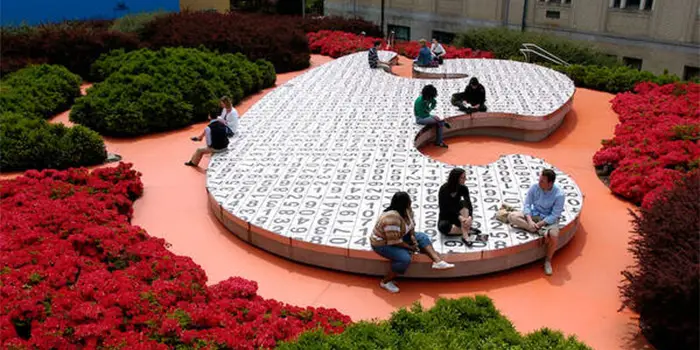 Students sitting on interactive campus art installation, the Kraus Campo.