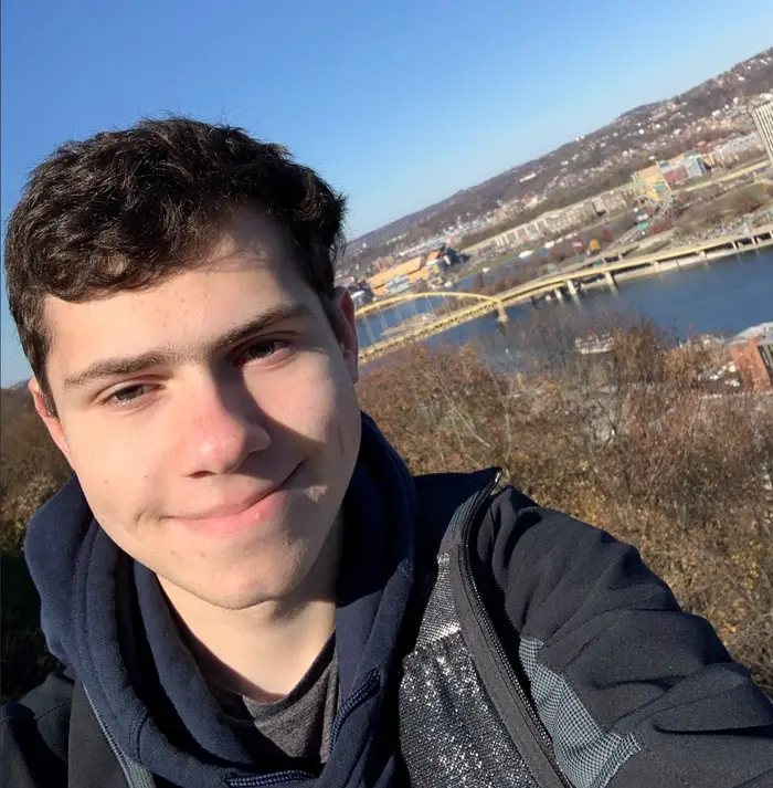 A selfie of Peter with Pittsburgh in the background.