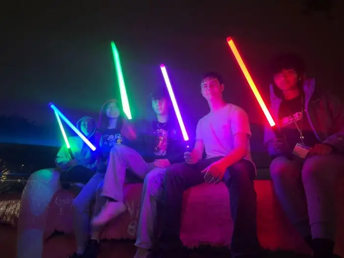 Maile and friends with lightsabers