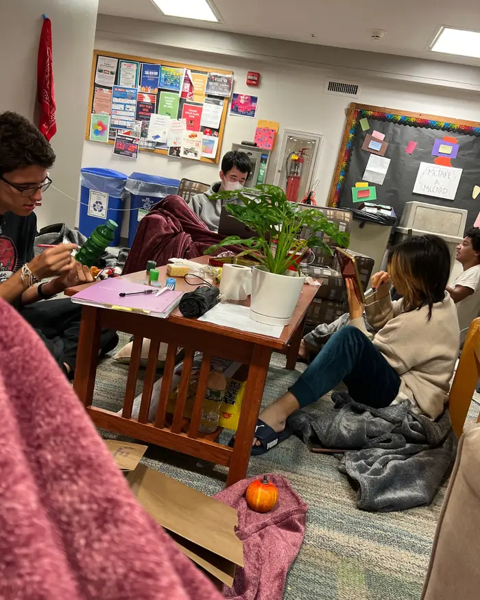 Bridget and friends doing crafts on the floor of their dorm lounge