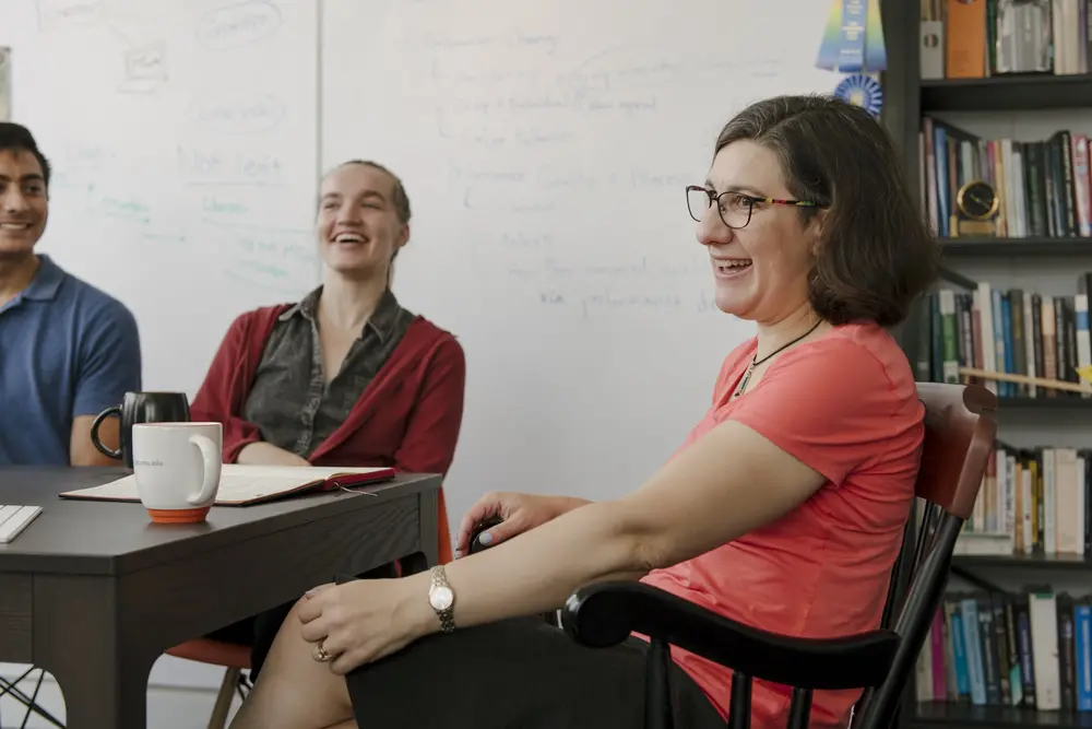 Students working with the professor during a psychology workshop.