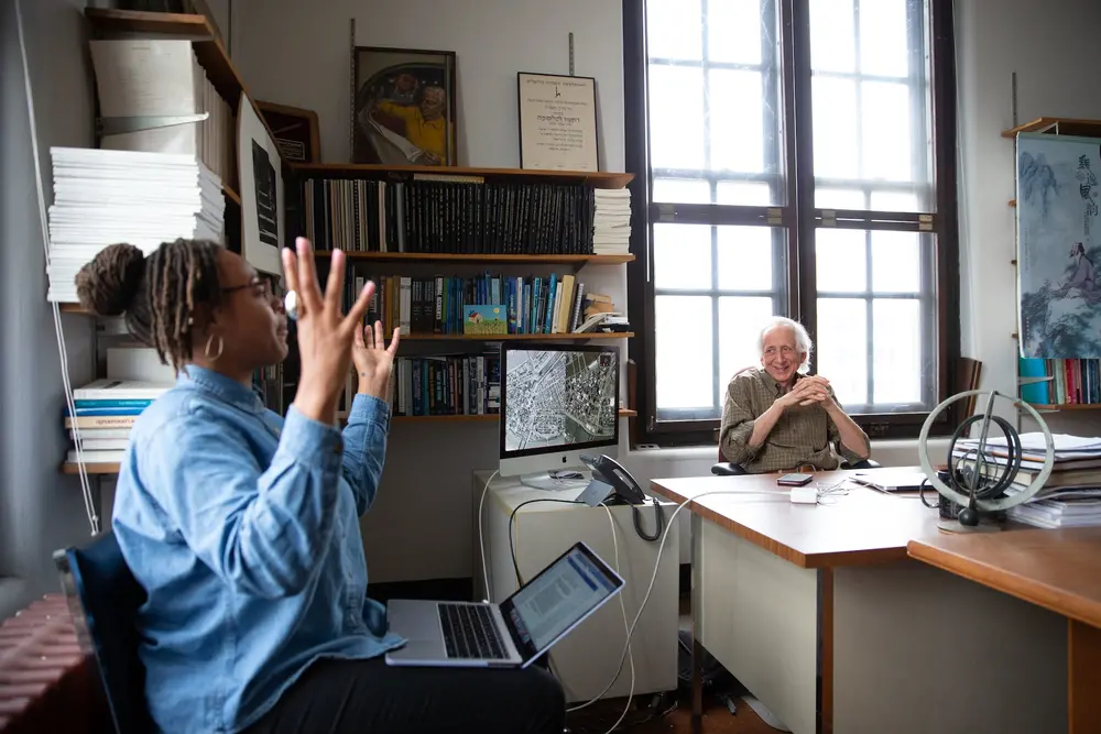 Student explaining her project to professor Baruch Fischoff.