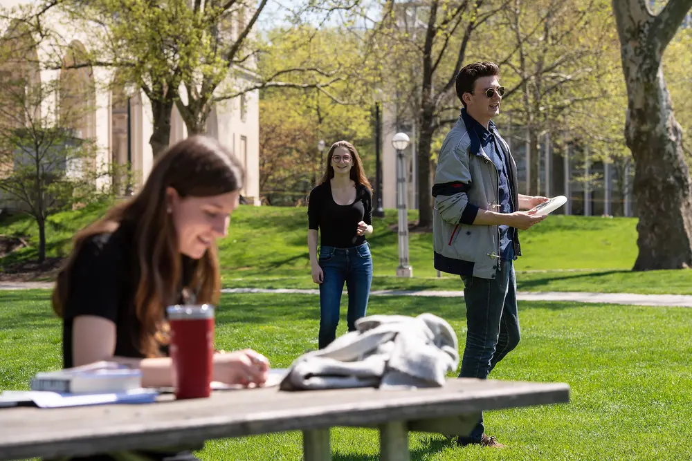 Students outdoor on CMU's campus studying and walking