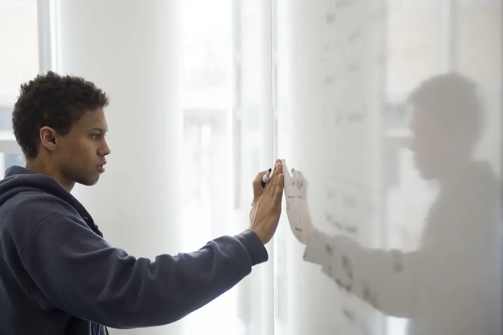 Student working at a whiteboard.